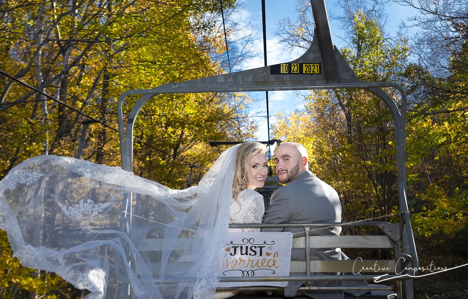 A Just Married couple sitting on a chairlift at Catamount Resort