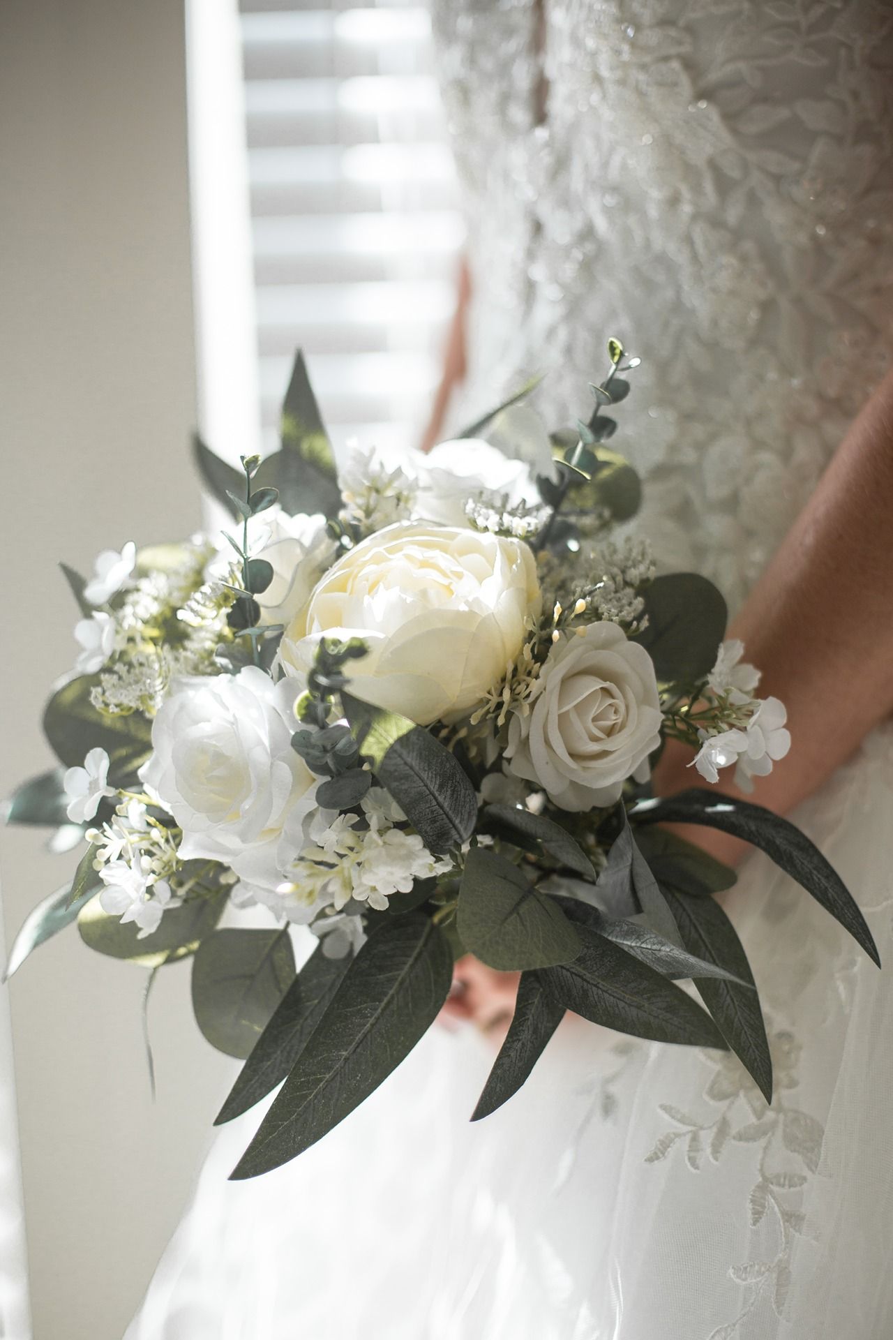 A bride holding a beautiful bouquet of flowers for a wedding at Catamount Resort
